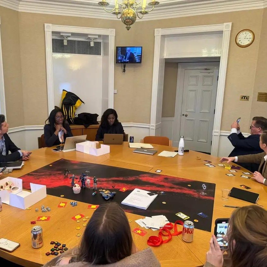 Mid Strategic Orbits Exercise®, a client team sits around a table with the SOE map and artefacts arranged before them.